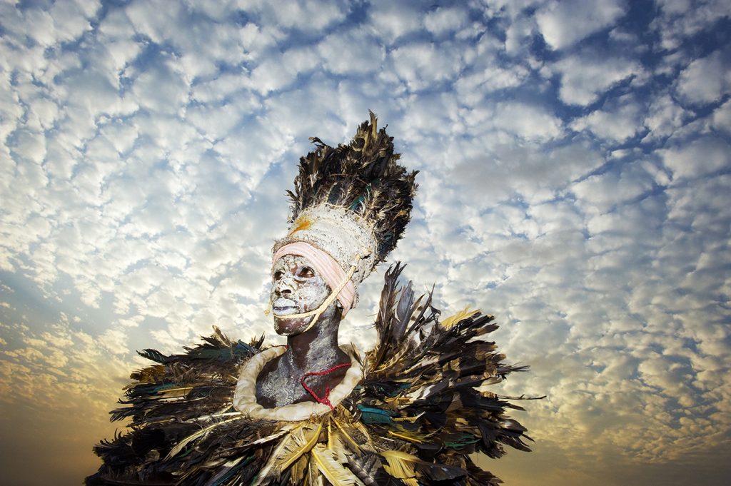 Photograph by humanitarian photographer Jonathan Banks of a traditional West African dancer waiting to perform, Liberia
